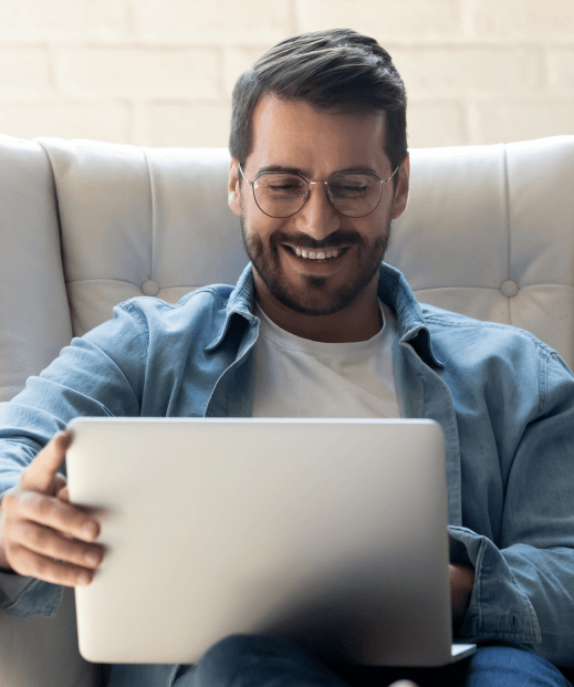 Man smiling at computer